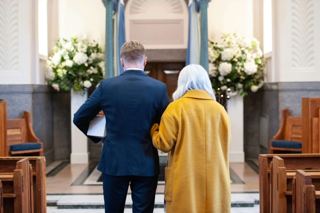 Man and woman dressed in colour at funeral